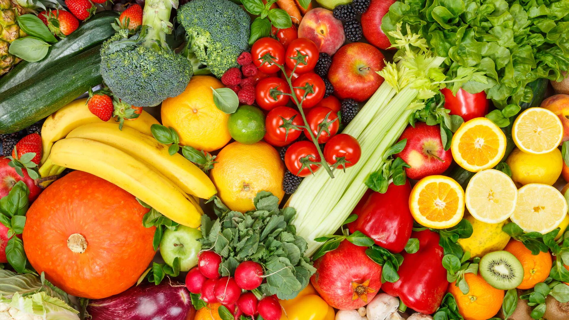 Eine umfangreiche Sammlung von Obst- und Gemüsesorten bedeckt einen Tisch.